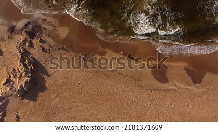 One person strolling on sandy beach at sunrise, Punta del Este in Uruguay. Aerial top-down view. Royalty-Free Stock Photo #2181371609