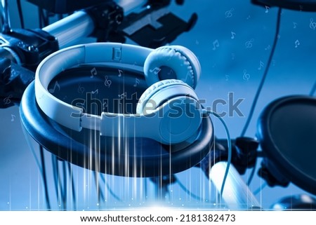 Modern headphones with illustration musical notes on light background, toned in blue