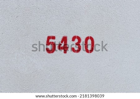 Red Number 5430 on the white wall. Spray paint.
