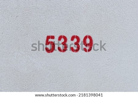 Red Number 5339 on the white wall. Spray paint.
