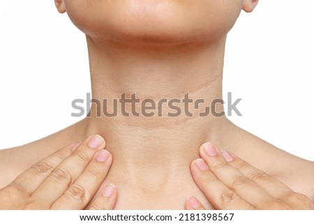 Cropped shot of a young woman touching her neck with her hands isolated on a white background. Lines on the female neck. Wrinkles, age-related changes, rings of Venus, goosebumps Royalty-Free Stock Photo #2181398567