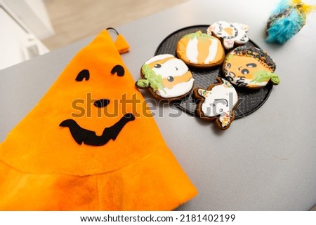 Step by step instructions on how to draw an orange pumpkin shaped gingerbread cookie using icing. DIY Master class from pastry chef in six steps. Halloween sweets on an isolated background.Copy space.