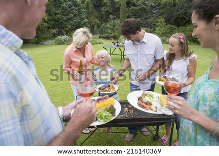 Multi-generation family serving barbecue