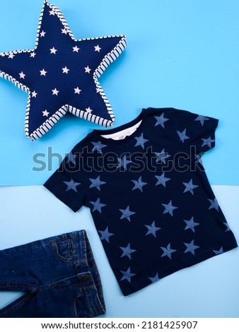 kids blue t shirt with stars on background 