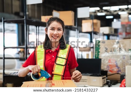 Warehouse worker checking and scanning a barcode on box package in the background warehouse., Industrial and industrial concept.
