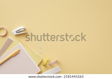 Back to school concept. Top view photo of stationery diaries pen ruler clips mini stapler and adhesive tape on isolated pastel yellow background with copyspace Royalty-Free Stock Photo #2181445263