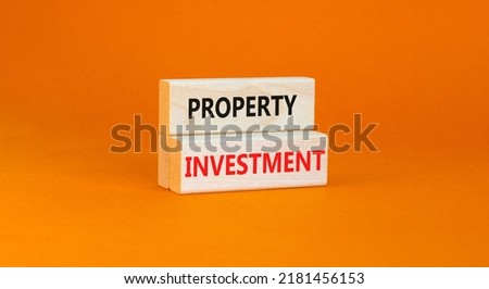 Property investment symbol. Concept words Property investment on wooden blocks on a beautiful orange table orange background. Business Property investment concept. Copy space.