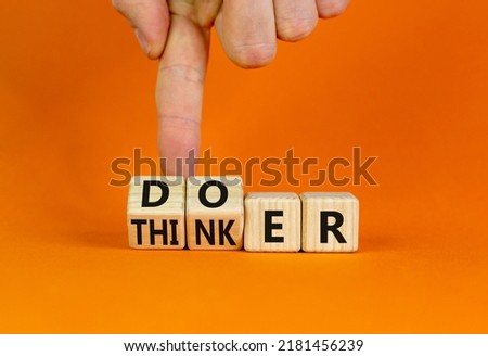 Doer or thinker symbol. Concept words Doer or thinker on wooden cubes. Businessman hand. Beautiful orange table orange background. Business and doer or thinker concept. Copy space. Royalty-Free Stock Photo #2181456239
