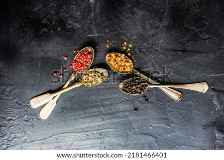 Variety of pepper spice on black concrete background