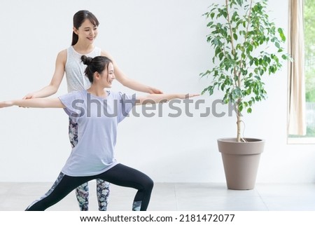 Young Asian women doing yoga indoors
