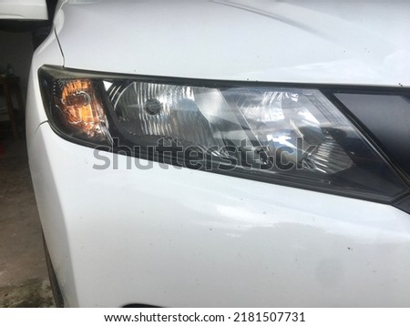 Car headlight bulbs on a white car