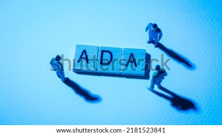 Miniature figures businessman : meeting on ADA word by wooden block words on white paper background in blue light, ADA or Cordano  in concept of digital money, cryptocurrency and business. Royalty-Free Stock Photo #2181523841
