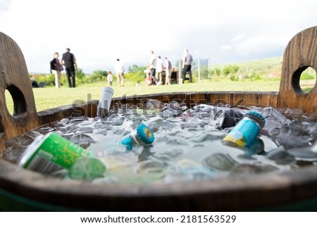 Picture of a party bucket full of beer bottles and ice cubes
