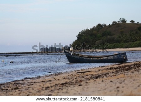 fishing boat anchored on the beach, picture taken during the day