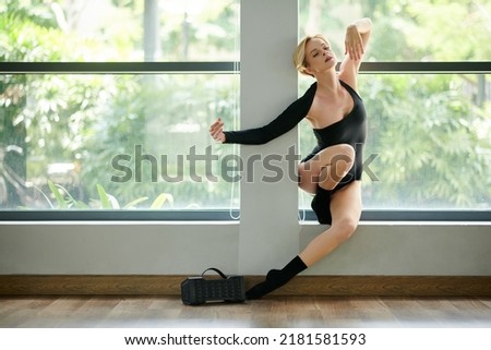 Graceful dancer making smooth and beautiful dance movement to music in speaker