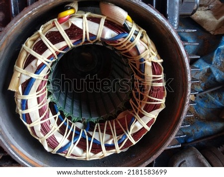 close up photo of an electric motor being repaired.  shows the inside of the motor, windings, and stator being maintained. pump repair