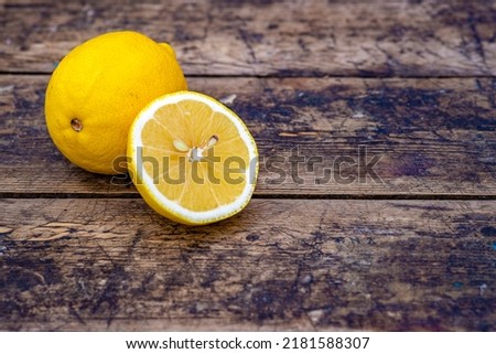 Fresh organic lemons Summer fruit, old wood table, Still Life, green nature background wood stump trunk outdoor, ripe yellow