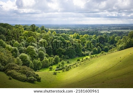 UK countryside landscape. Green rolling hills with trees and meadow. View from Chiltern Hills toward Aylesbury Vale. Buckinghamshire, UK Royalty-Free Stock Photo #2181600961
