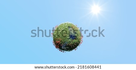 Creative abstract global ecology and environment protection business concept: mini green Earth planet globe with world map with green grass and color meadow flowers isolated on blue sky
