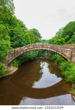 Beggar’s bridge, is a single track medieval packhorse bridge in Glaisdale, Yorkshire. Built by Tom Ferris in 1619, parts are from a former bridge of the 14th century. Single arch over the river Esk. Royalty-Free Stock Photo #2181613509