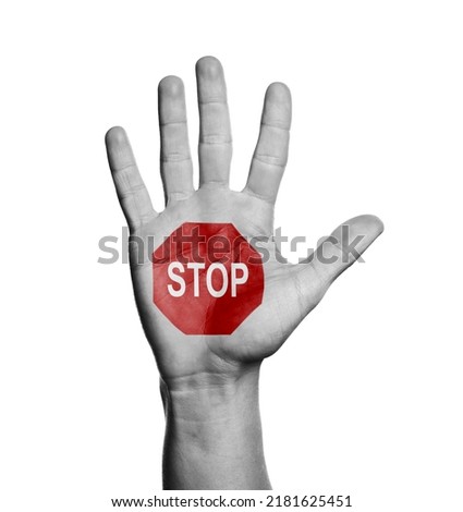 Woman showing palm with drawn STOP sign on white background, closeup