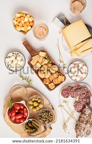 Appetizers table with different antipasti, charcuterie, snacks, cheese. Finger food for buffet party. Traditional french or italian entires. Top view Royalty-Free Stock Photo #2181634391