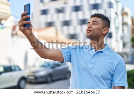 African american man smiling confident making selfie by the smartphone at street