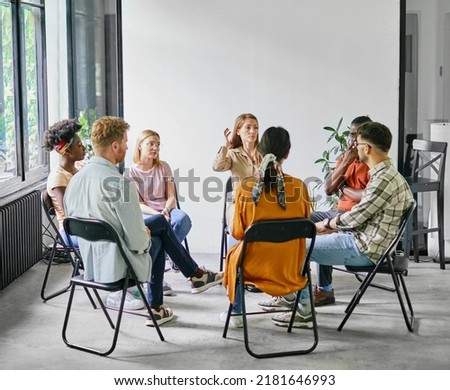 Group psychotherapy. Persons sitting in circle and talking. People meeting. Psychotherapy training, business lecture or conference. Man woman support group Royalty-Free Stock Photo #2181646993