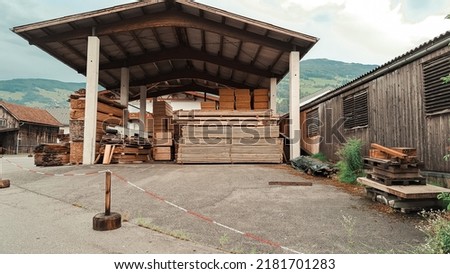 Big storage of wooden bricks in the village in mountains. High quality photo