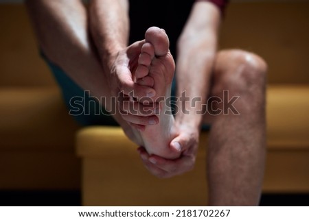Adult male with foot pain, dislocation, numbness, cramp and other joint issues. Royalty-Free Stock Photo #2181702267