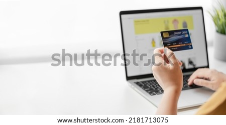 Woman holding credit card shopping online with laptop computer. Online shopping concept.