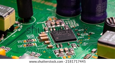 Macro Close up of components and microchips on PC circuit board of modem router	 Royalty-Free Stock Photo #2181717445
