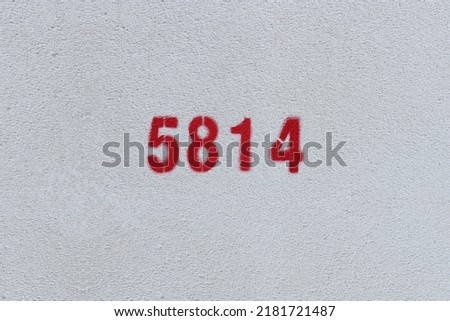 Red Number 5814 on the white wall. Spray paint.
