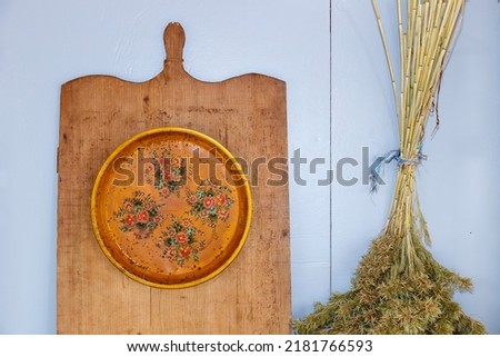 yellow kitchen objects and decor, wooden board and plate with decorative branches - blue top