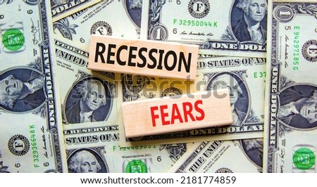 Recession fears symbol. Concept words Recession fears on wooden blocks on a beautiful background from dollar bills. Business and recession fears concept. Copy space. Royalty-Free Stock Photo #2181774859