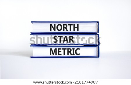 North star metric symbol. Concept words North star metric on books on a beautiful white table white background. Business finacial and north star metric concept. Copy space.