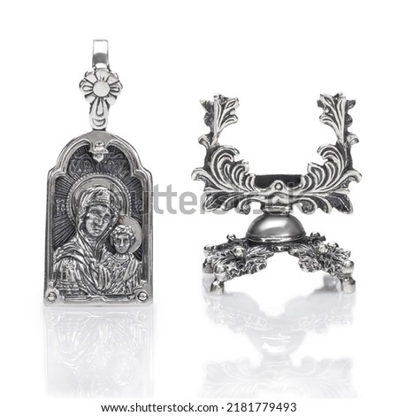 Silver pendant with the image of the holy virgin Mary isolated on white.
