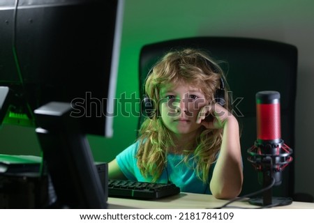 Blogging and gaming concept. Kid or blogger with pc computer recording video at home. Distance education concept. Kids online learning.
