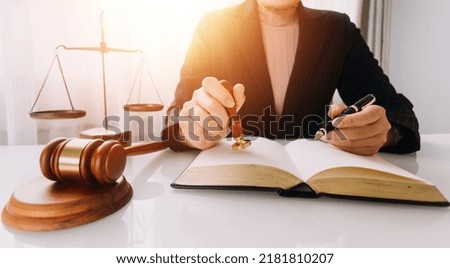 Business and lawyers discussing contract papers with brass scale on desk in office. Law, legal services, advice, justice and law concept