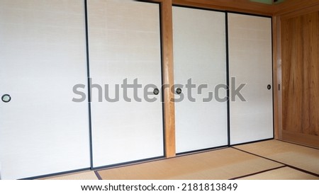 Japanese style room.Japanese fusuma and tatami room.Fusuma is a Japanese sliding screen.The tatami mat is a Japanese straw floor covering. Royalty-Free Stock Photo #2181813849