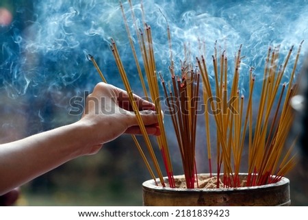 Taoist temple. Emperor Jade pagoda (Chua Phuoc Hai).  Incense sticks on joss stick pot are burning and smoke use for pay respect to the Buddha. Ho Chi Minh City. Vietnam.  Royalty-Free Stock Photo #2181839423