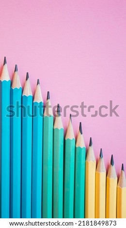 Colored wooden pencils on pink background. Top view with copy space. Flat lay. Back to school, education concept.