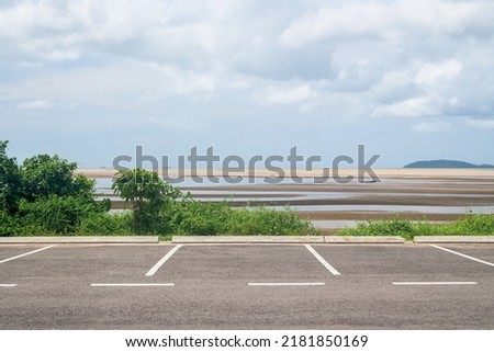 Empty parking lot against sea and beautiful blue sky.