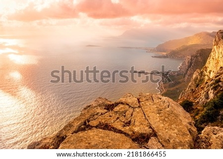 amazing panoramic view from a high rock to  sunset or sunrise sea in evening or morning with coastline and mountains far below with beautiful clouds