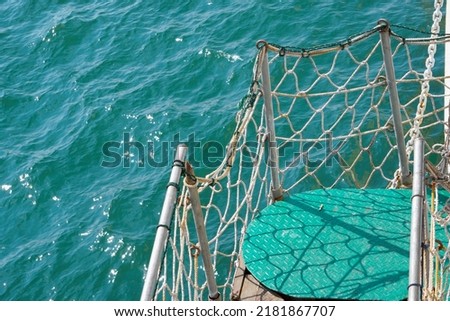 Stairs or walkways on passenger ships which are fenced with nets to maintain the safety of passengers. This photo is just right for shipping safety needs etc.                 Royalty-Free Stock Photo #2181867707
