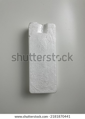 one piece of white cardboard cork on a white background