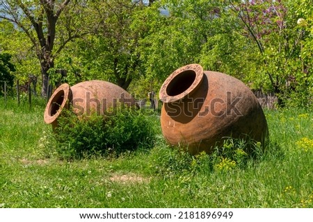 Georgian traditional jugs kvevri for wine, outdoor. Ethnography museum, Tbilisi Royalty-Free Stock Photo #2181896949