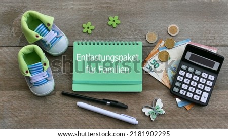 The German text Entlastungspaket für Familien, Entlastungspaket für Familien translated means relief package for families. Royalty-Free Stock Photo #2181902295