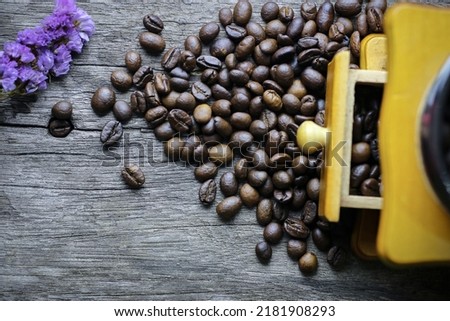 picture of coffee beans stacked on wooden floor on a dark background with copy space