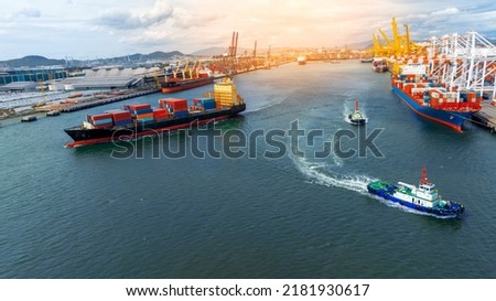 Cargo container ship carrying container and running near Tug boat in international custom shipyard sea port concept smart logistic service. Express boat Royalty-Free Stock Photo #2181930617